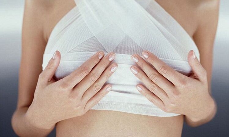 bandaged breast after breast augmentation surgery